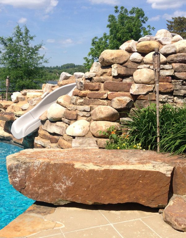 Pool with stone encased water slide
