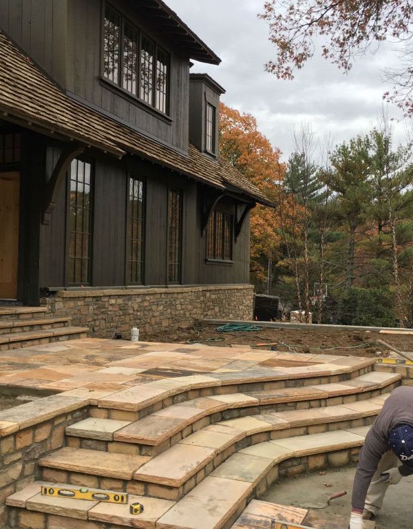 Single level house with stone veneer and tiered stone patio